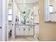 A bright bathroom with a large mirror, neutral tile, and black hardware at 4386 Library St, Port Charlotte, FL 33948