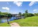 Tranquil waterfront view of a private boat dock and canal, surrounded by lush landscaping at 4386 Library St, Port Charlotte, FL 33948