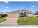 Charming single-Gathering home with a well-manicured lawn, paved driveway, and three-car garage at 4386 Library St, Port Charlotte, FL 33948