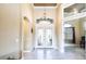 Elegant foyer with decorative front doors, soaring ceilings, and a stylish chandelier at 4386 Library St, Port Charlotte, FL 33948