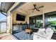 Cozy covered lanai area featuring a flatscreen television, wet bar, mini refrigerator and a comfortable seating area at 4386 Library St, Port Charlotte, FL 33948