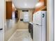 Well-lit laundry room with ample cabinetry, a laundry sink, and newer washer and dryer units at 4386 Library St, Port Charlotte, FL 33948