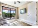 Bright living room featuring patio access, a ceiling fan, and tiled floors at 4386 Library St, Port Charlotte, FL 33948
