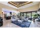 Spacious living room with modern decor, large windows, and an open floor plan to the kitchen at 4386 Library St, Port Charlotte, FL 33948