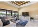 Comfortable living room with sliding glass doors to the lanai, a large TV, and a stylish blue rug at 4386 Library St, Port Charlotte, FL 33948