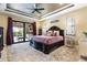 This is a beautiful bedroom with a large bed, ceiling fan, and sliding glass doors to the patio at 4386 Library St, Port Charlotte, FL 33948