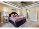 Bright main bedroom boasts a decorative ceiling, ceiling fan, walk-in closets, and neutral paint at 4386 Library St, Port Charlotte, FL 33948