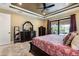 A spacious main bedroom with a ceiling fan, slider door access, and a dark wood dresser with ornate mirror at 4386 Library St, Port Charlotte, FL 33948