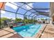 Screened-in pool, brick patio, outdoor dining area and waterfront views offer the best in outdoor living and entertaining at 4386 Library St, Port Charlotte, FL 33948