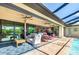 Covered lanai and a beautiful pool area with comfortable seating, a ceiling fan and a partial view into the main house at 4386 Library St, Port Charlotte, FL 33948