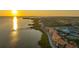 A captivating aerial view of beachfront condos with terracotta tile roofs and lush landscaping on Sarasota Bay at 4535 Bay Club Dr, Bradenton, FL 34210