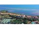 Aerial view of complex with red tiled roofs, tennis courts, pool, and waterfront location at 4535 Bay Club Dr, Bradenton, FL 34210