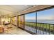 Screened in balcony with tile floors, telescope and furniture overlooking the ocean at 4535 Bay Club Dr, Bradenton, FL 34210