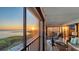 Screened in balcony featuring a telescope and sunset views over the bay at 4535 Bay Club Dr, Bradenton, FL 34210
