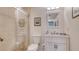Bright bathroom featuring a glass-enclosed shower, white vanity, and neutral tile at 4535 Bay Club Dr, Bradenton, FL 34210