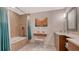 Updated bathroom features tub, shower, decorative tilework, vanity, and great lighting at 4535 Bay Club Dr, Bradenton, FL 34210