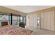 Bright bedroom with water view and ensuite lanai features two closets and neutral tones at 4535 Bay Club Dr, Bradenton, FL 34210