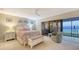 Cozy bedroom with water views features a ceiling fan and an ensuite lanai at 4535 Bay Club Dr, Bradenton, FL 34210