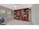 Bedroom featuring a large bookshelf, desk, closet, and neutral carpeting at 4535 Bay Club Dr, Bradenton, FL 34210