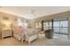 Cozy bedroom with water views features a ceiling fan and an ensuite lanai at 4535 Bay Club Dr, Bradenton, FL 34210