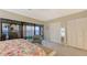 Bright bedroom with water view and ensuite lanai features two closets and neutral tones at 4535 Bay Club Dr, Bradenton, FL 34210