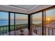 Dining room featuring panoramic water views, wood railing, and serene atmosphere at 4535 Bay Club Dr, Bradenton, FL 34210