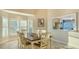 Dining area with bay windows, a wooden table, and six white chairs at 4535 Bay Club Dr, Bradenton, FL 34210