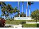 Exterior view of the IMG Academy entrance sign, framed by manicured hedges and majestic palm trees at 4535 Bay Club Dr, Bradenton, FL 34210