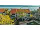 Exterior view of a multi-story home with a red tile roof and lush landscaping at 4535 Bay Club Dr, Bradenton, FL 34210