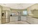 Bright kitchen featuring stainless steel appliances, white cabinets, and a view to the water at 4535 Bay Club Dr, Bradenton, FL 34210