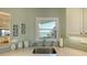 Kitchen sink with accessories, quartz countertop, backsplash, and water view at 4535 Bay Club Dr, Bradenton, FL 34210