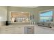 Kitchen sink area with stainless dishwasher, quartz countertops, and ocean view window at 4535 Bay Club Dr, Bradenton, FL 34210