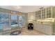Bright kitchen and eating area featuring custom cabinetry and views of outdoors at 4535 Bay Club Dr, Bradenton, FL 34210
