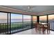 The lanai features incredible waterfront views and a table for casual dining at 4535 Bay Club Dr, Bradenton, FL 34210