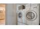 Convenient laundry area with stacked washer and dryer units, and storage space at 4535 Bay Club Dr, Bradenton, FL 34210
