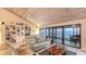 Bright living room with water view through sliding glass doors and a built in bookcase at 4535 Bay Club Dr, Bradenton, FL 34210