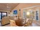 Living room with water views, fireplace, TV, and dining room table and chairs at 4535 Bay Club Dr, Bradenton, FL 34210