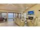 Inviting living room featuring a fireplace, comfortable seating, and a scenic water view at 4535 Bay Club Dr, Bradenton, FL 34210