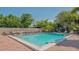 Inviting community pool featuring comfortable lounge chairs and lush landscaping at 4535 Bay Club Dr, Bradenton, FL 34210