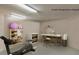 Staged storage room with exercise equipment and workspace at 4535 Bay Club Dr, Bradenton, FL 34210