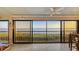 Beautiful view of the water through sliding glass doors leading to outdoor balcony at 4535 Bay Club Dr, Bradenton, FL 34210