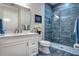 Modern bathroom showcasing a walk-in shower, vanity with white cabinetry, and sleek fixtures at 5103 Windward Ave, Sarasota, FL 34242