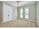 Empty bedroom featuring neutral carpet, paint, and natural light streaming through the windows at 5103 Windward Ave, Sarasota, FL 34242