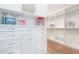 Spacious walk-in closet offering ample storage with custom shelving and drawers at 5103 Windward Ave, Sarasota, FL 34242