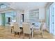 Dining area with patio access, a custom-built bar, and hardwood floors at 5103 Windward Ave, Sarasota, FL 34242