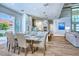 Bright dining room featuring a modern table set with seating for six, next to the living area at 5103 Windward Ave, Sarasota, FL 34242