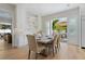 Bright dining room featuring a modern table set with seating for six, next to an open patio at 5103 Windward Ave, Sarasota, FL 34242