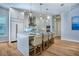 Bright modern kitchen with an island, seating, stainless appliances, and sleek cabinetry, perfect for entertaining at 5103 Windward Ave, Sarasota, FL 34242