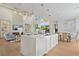 Open-concept kitchen and living area featuring a large island, modern lighting, and seamless access to outdoor living at 5103 Windward Ave, Sarasota, FL 34242