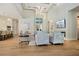 Open-concept living room featuring high ceilings, a fireplace, and adjacent kitchen and dining areas at 5103 Windward Ave, Sarasota, FL 34242